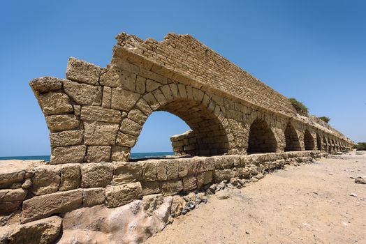 Ancient Roman aqueduct in Ceasarea at the coast of the Mediterranean Sea, Israel built by Herod, Israel