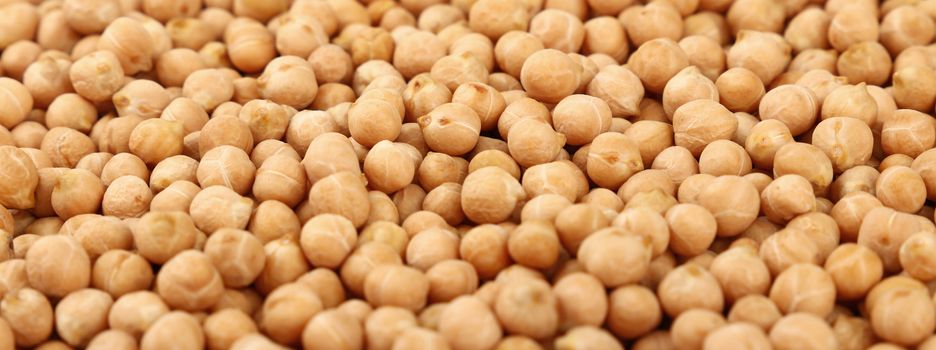 Dried chickpea beans at retail market display, close up pattern background, low angle view