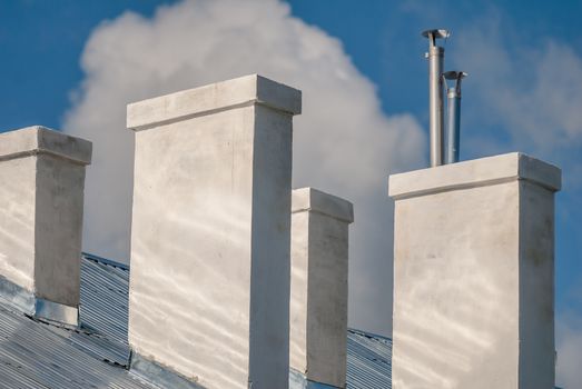 chimneys on the roof of the house in a sunny day