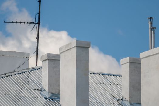 chimneys on the roof of the house in a sunny day