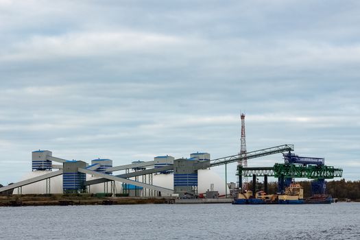 Blue cargo ship loading in the port of Riga, Europe
