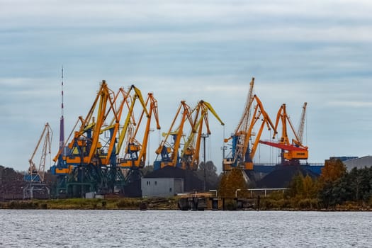 Yellow cargo cranes in the port of Riga, Europe