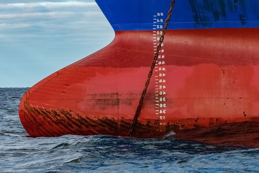 Blue cargo ship moored in still Baltic sea water