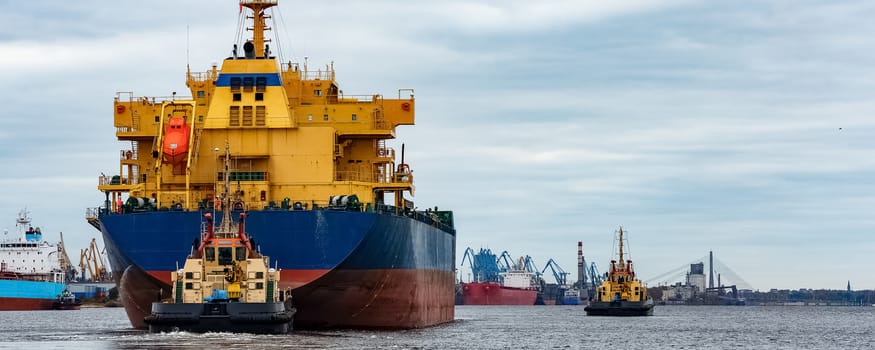 Blue cargo ship entering the port of Riga, Europe