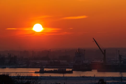 Hot orange sunset over the river. Urban landscape
