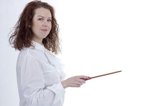 Young woman is pointing out something with a pointer on a blackboard