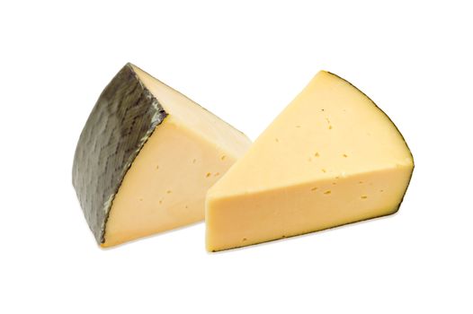 Two pieces of the hard cheese on a light background
