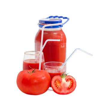 Big fresh whole tomato with bendable drinking straw inserted into it, half of the tomato, tomato juice in glass jar and in two different glasses with drinking straws on a light background
