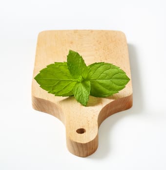 fresh mint leaves on wooden cutting board