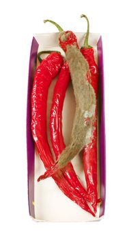 shrinking and mouldy chili peppers in paper box