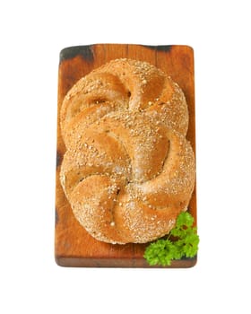 two whole wheat buns on wooden cutting board