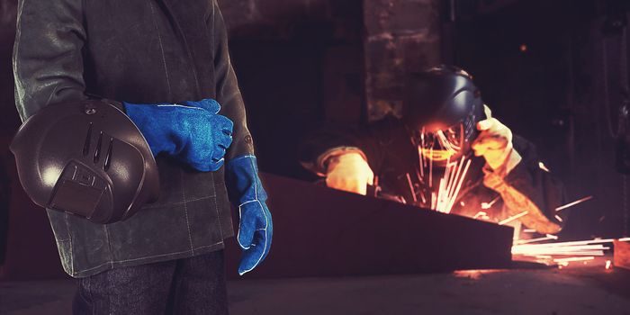 Welder in the workshop at the factory