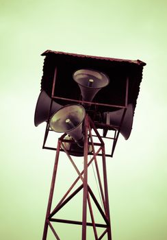 Old public loudspeakers broadcast on high tower with long distance tower