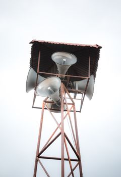 Old public loudspeakers broadcast on high tower with long distance tower