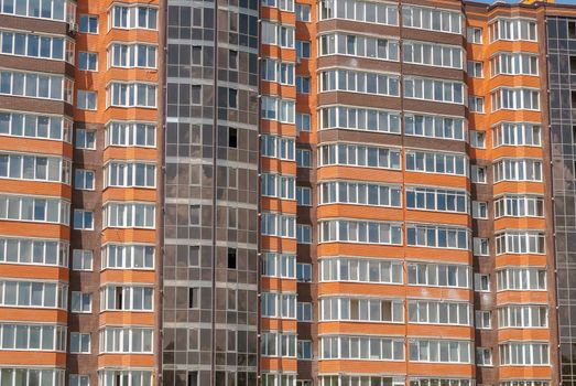 kind of a new multistorey brick residential building on a sunny day