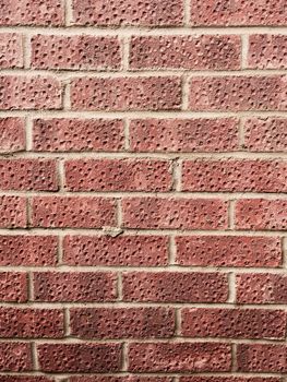 Brown vintage brick wall with clean structure. Old house facade.