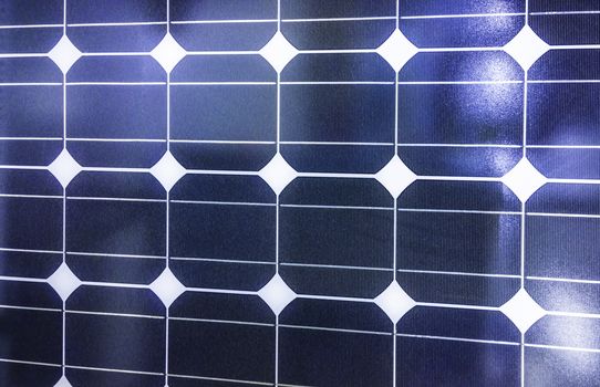 Closeup of blue photovoltaic solar panels background