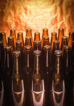 Rows of brown color empty bottles beer