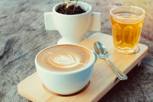 latte art coffee or cappuccino on wooden table background.