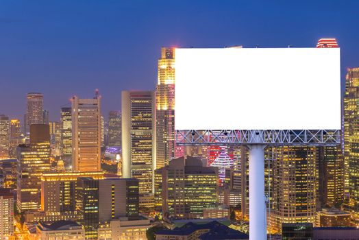 Blank billboard for advertisement in city downtown at night.