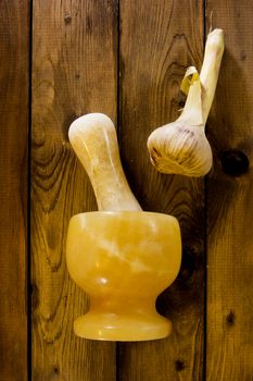 Garlic in mortar and pestle on a wooden background