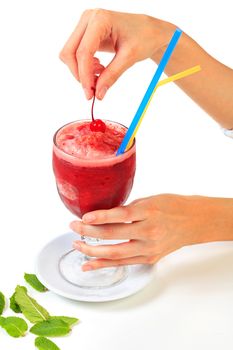 Cherry smoothie in a big glass cup with two straws in woman's hands, isolated on white background