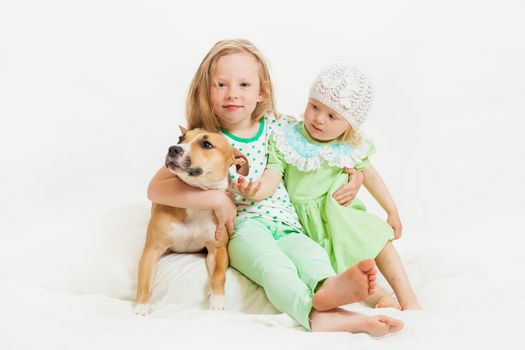 two little girls and dog on the isolated background