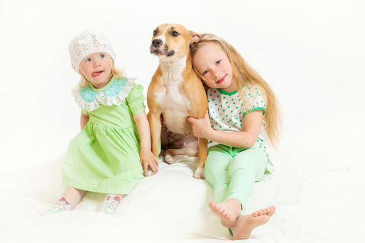 two little girls and dog on the isolated background