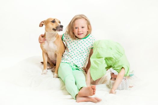 two little girls and dog on the isolated background