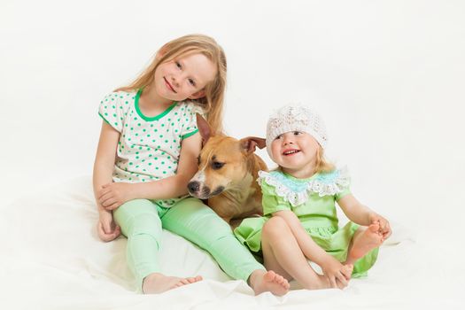 two little girls and dog on the isolated background