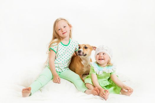 two little girls and dog on the isolated background