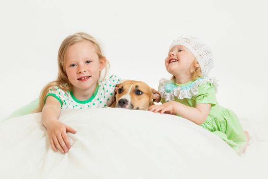 two little girls and dog on the isolated background