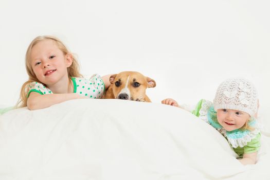 two little girls and dog on the isolated background