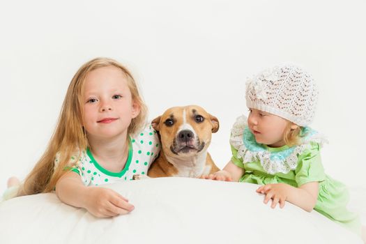 two little girls and dog on the isolated background