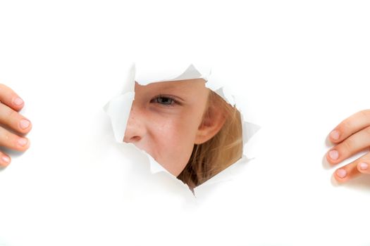 the little girl looks out through a hole in paper