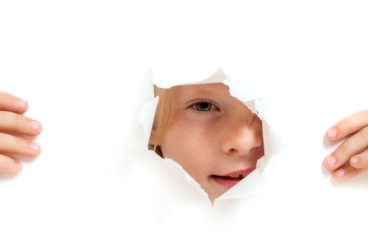 the little girl looks out through a hole in paper