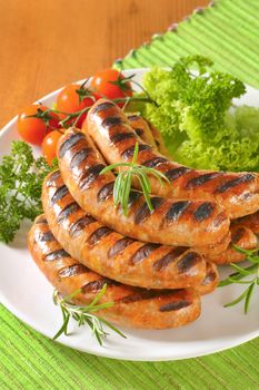 Pile of grilled sausages on plate