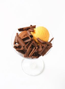 Scoops of ice cream with chocolate curls in stemmed glass