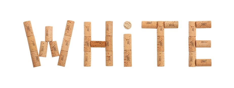Word WHITE shaped by natural wooden wine bottle corks of different vintage years isolated on white background