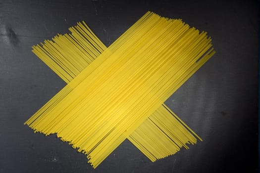 Beam of Italian pasta on a black background