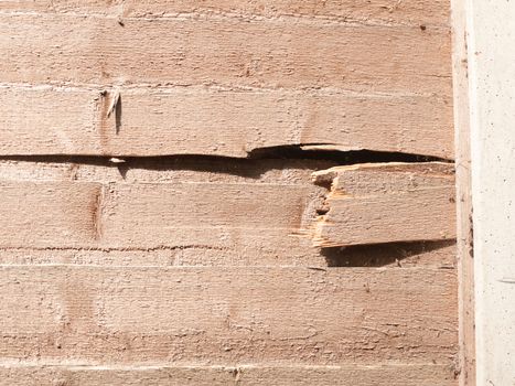 broken brown light wooden fence outside close up rough splinters