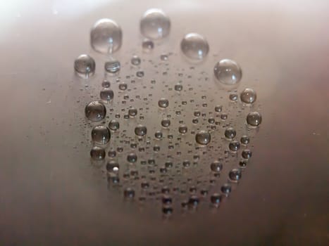 a circle of bubbles on top of a grey shiny surface detail