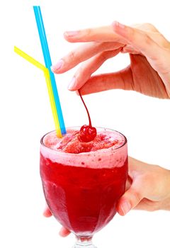 Closeup shot of cherry smoothie in a big glass cup with two straws in woman's hands, isolated on white background