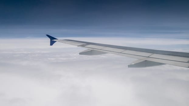 The airplane wing on the beautiful cloudy and sky.