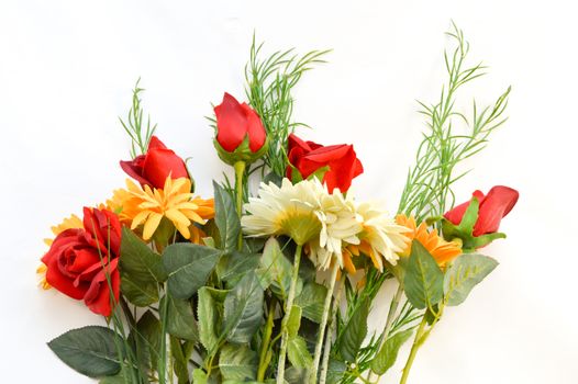 Bouquet of red roses and daisies on white background