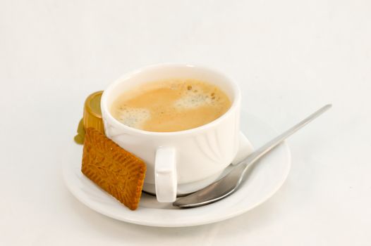 Cup of black coffee with a speculoos on white background