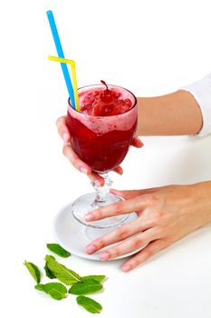 Closeup shot of a cherry smoothie in a big glass cup with two straws in woman's hands. Isolated on white background. Lady with a drink