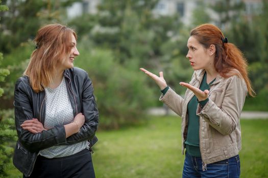 Mother and daughter communicating emotionally outdoor