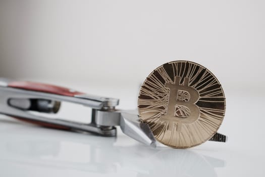 Cryptocurrency physical gold bitcoin coin and pocket knife. Men's toys.