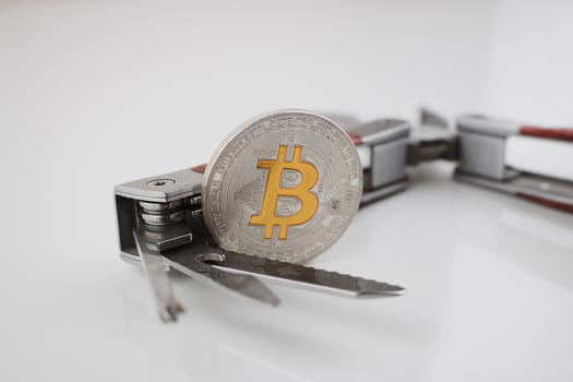 Digital currency physical silver bitcoin coin and pocket knife. Man's toys.